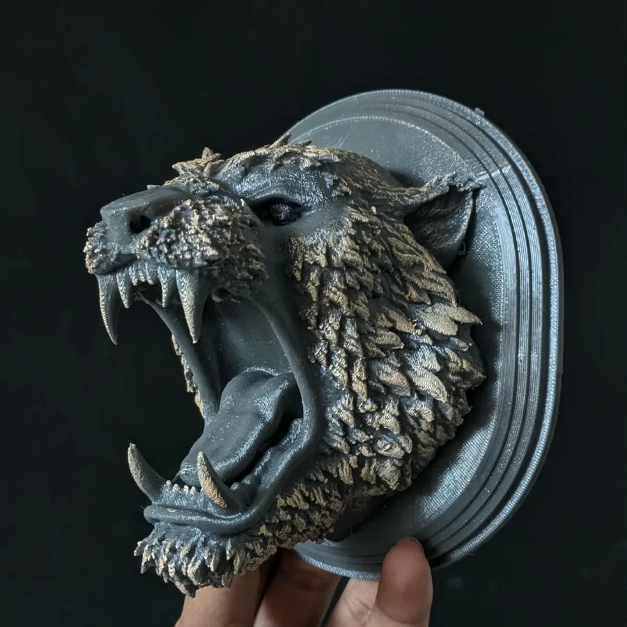 3D printed snarling wolf head wall mount held in hand